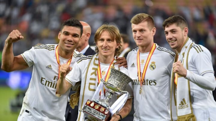 TOPSHOT - (L to R) Real Madrid's Brazilian midfielder Casemiro, Real Madrid's Croatian midfielder Luka Modric, Real Madrid's German midfielder Toni Kroos and Real Madrid's Uruguayan midfielder Federico Valverde pose with the trophy after winning the Spanish Super Cup final between Real Madrid and Atletico Madrid on January 12, 2020, at the King Abdullah Sports City in the Saudi Arabian port city of Jeddah. (Photo by FAYEZ NURELDINE / AFP) (Photo by FAYEZ NURELDINE/AFP via Getty Images)