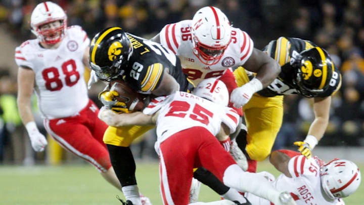 IOWA CITY, IA- NOVEMBER 25: Running back LeShun Daniels No. 29 of the Iowa Hawkeyes is tackled in the fourth quarter by safety Nathan Gerry No. 25 and defensive tackle Carlos Davis No. 95 of the Nebraska Cornhuskers, on November 25, 2016 at Kinnick Stadium in Iowa City, Iowa. (Photo by Matthew Holst/Getty Images) IOWA CITY, IA- NOVEMBER 25: Running back LeShun Daniels No. 29 of the Iowa Hawkeyes is tackled in the fourth quarter by safety Nathan Gerry No. 25 and defensive tackle Carlos Davis No. 95 of the Nebraska Cornhuskers, on November 25, 2016 at Kinnick Stadium in Iowa City, Iowa. (Photo by Matthew Holst/Getty Images)