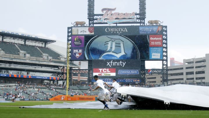 DETROIT, MI - AUGUST 29: Comerica Park ground crew covers the infield as rain falls during the fifth inning of the Detroit Tigers game against the Toronto Blue Jays on August 29, 2021, in Detroit, Michigan. (Photo by Duane Burleson/Getty Images)