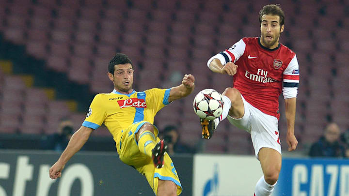 Arsenal's French midfielder Mathieu Flamini vies with Napoli's Swiss midfielder Blerim Dzemaili (L) during the UEFA Champions League group F football match between SSC Napoli and Arsenal FC at the San Paolo Stadium in Naples on December 11, 2013. AFP PHOTO / GABRIEL BOUYS (Photo credit should read GABRIEL BOUYS/AFP/Getty Images)
