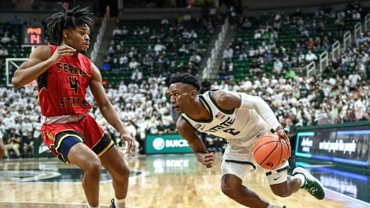 Michigan State’s Tyson Walker, right, drives to the basket as Ferris State’s Reese McDonald defends during the first half on Wednesday, Oct. 27, 2021, at the Breslin Center in East Lansing.211027 Msu Ferris 012a