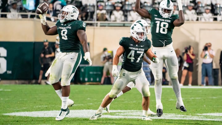 EAST LANSING, MI – SEPTEMBER 02: Simeon Barrow #8 of Michigan State celebrates his fumble recovery late in the second quarter against Western Michigan with teammates Jeff Pietrowski #47 and Zion Young #18 at Spartan Stadium on September 2, 2022 in East Lansing, Michigan. (Photo by Jaime Crawford/Getty Images)