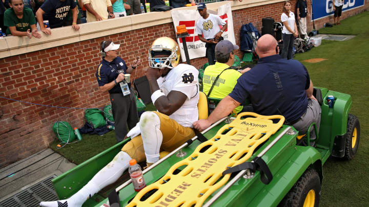 CHARLOTTESVILLE, VA – SEPTEMBER 12: Quarterback Malik Zaire #8 of the Notre Dame Fighting Irish is carted off of the field after being injured against the Virginia Cavaliers in the third quarter at Scott Stadium on September 12, 2015, in Charlottesville, Virginia. The Notre Dame Fighting Irish won, 34-27. (Photo by Patrick Smith/Getty Images)