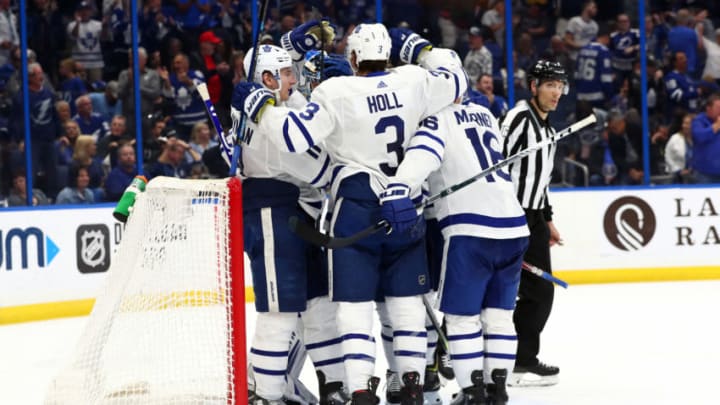 Feb 25, 2020; Tampa, Florida, USA; Toronto Maple Leafs left wing Zach Hyman (11) and defenseman Justin Holl (3) and right wing Mitchell Marner (16) and teammates celebrate after they beat the Tampa Bay Lightning at Amalie Arena. Mandatory Credit: Kim Klement-USA TODAY Sports