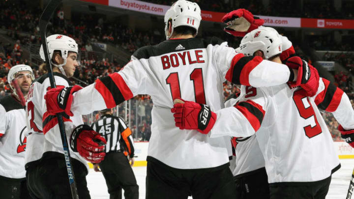 PHILADELPHIA, PA - OCTOBER 20: Brian Boyle #11 of the New Jersey Devils celebrates his third period goal against the Philadelphia Flyers with Kyle Palmieri #21, Nico Hischier #13, and Taylor Hall #9 on October 20, 2018 at the Wells Fargo Center in Philadelphia, Pennsylvania. (Photo by Len Redkoles/NHLI via Getty Images)