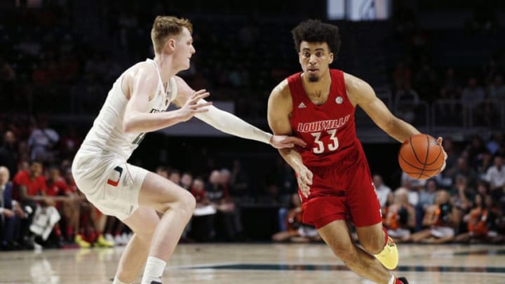 MIAMI, FLORIDA - NOVEMBER 05: Jordan Nwora #33 of the Louisville Cardinals drives to the basket against Sam Waardenburg #21 of the Miami Hurricanes during the first half at Watsco Center on November 05, 2019 in Miami, Florida. (Photo by Michael Reaves/Getty Images)