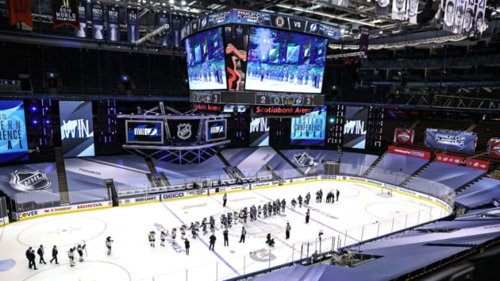 The Tampa Bay Lightning shake hands with the Boston Bruins (Photo by Elsa/Getty Images)