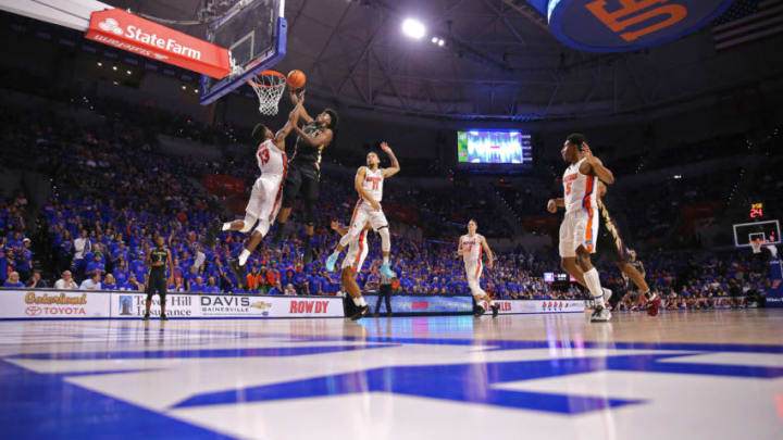 GAINESVILLE, FL - DECEMBER 04: Terance Mann #14 of the Florida State Seminoles scores in front of Kevarrius Hayes #13 and Chris Chiozza #11 of the Florida Gators during a NCAA basketball game at the Stephen C. O' Connell Center on December 4, 2017 in Gainesville, Florida. (Photo by Alex Menendez/Getty Images)