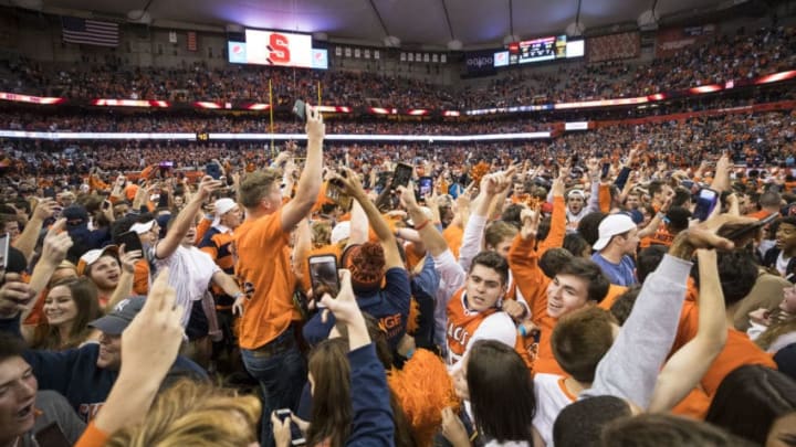 SYRACUSE, NY - OCTOBER 13: Syracuse Orange fans storm the field after the team upset Clemson Tigers at the Carrier Dome on October 13, 2017 in Syracuse, New York. Syracuse defeats Clemson 27-24. (Photo by Brett Carlsen/Getty Images)