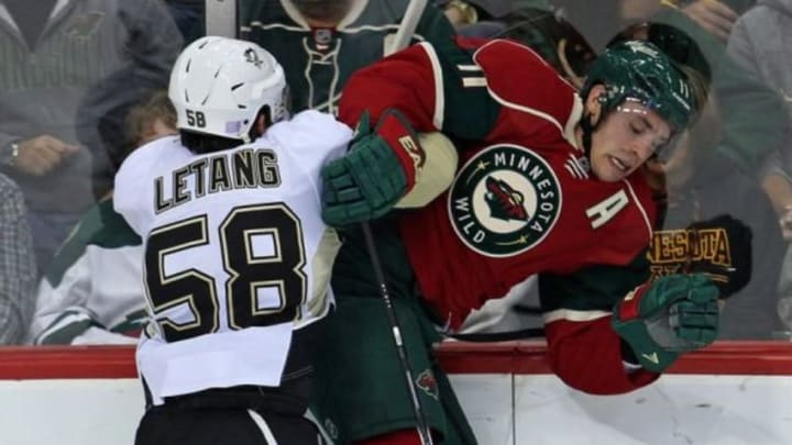 Nov 4, 2014; Saint Paul, MN, USA; Pittsburgh Penguins defenseman Kris Letang (58) checks Minnesota Wild forward Zach Parise (11) during the second period at Xcel Energy Center. Mandatory Credit: Brace Hemmelgarn-USA TODAY Sports