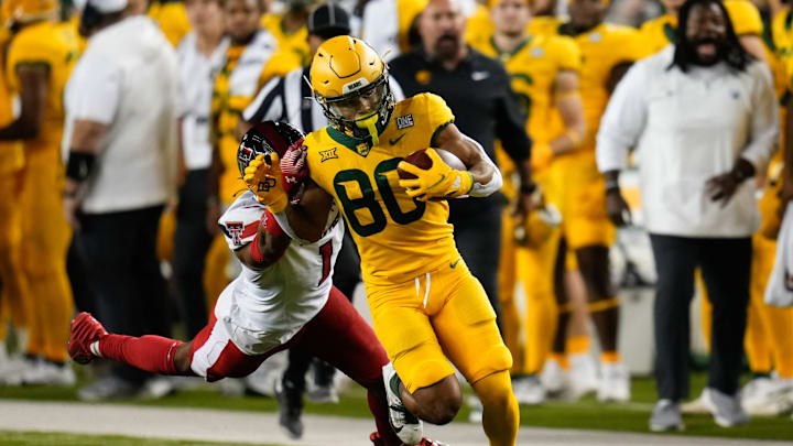 Oct 7, 2023; Waco, Texas, USA; Baylor Bears wide receiver Monaray Baldwin (80) makes a catch as Texas Tech Red Raiders defensive back Dadrion Taylor-Demerson (1) defends during the second half at McLane Stadium. Mandatory Credit: Chris Jones-USA TODAY Sports