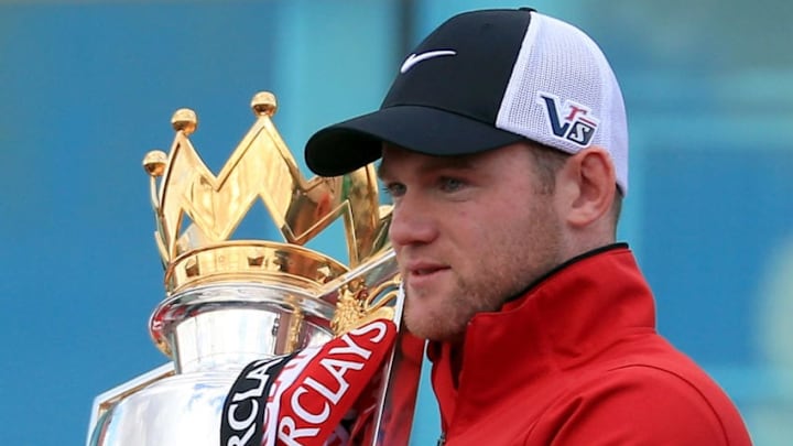 MANCHESTER, ENGLAND - MAY 13: Wayne Rooney of Manchester United poses with the Premier League trophy at the start of the Premier League trophy winners parade on May 13, 2013 in Manchester, England (Photo by Christopher Furlong/Getty Images)