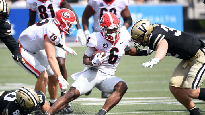 Sep 25, 2021; Nashville, Tennessee, USA; Georgia Bulldogs running back Kenny McIntosh (6) tries to avoid a tackle from Vanderbilt Commodores linebacker Ethan Barr (32) during the first half at Vanderbilt Stadium. Mandatory Credit: Christopher Hanewinckel-USA TODAY Sports