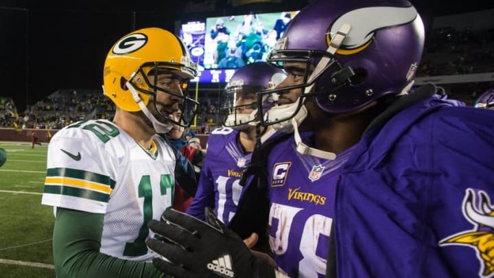 Nov 22, 2015; Minneapolis, MN, USA; Green Bay Packers quarterback Aaron Rodgers (12) and Minnesota Vikings running back Adrian Peterson (28) talk following the game at TCF Bank Stadium. The Packers defeated the Vikings 30-15. Mandatory Credit: Brace Hemmelgarn-USA TODAY Sports