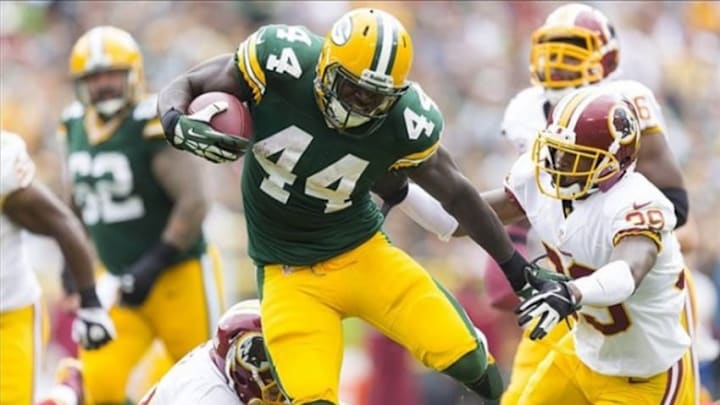 Sep 15, 2013; Green Bay, WI, USA; Green Bay Packers running back James Starks (44) rushes with the football as Washington Redskins cornerback David Amerson (39) defends during the third quarter at Lambeau Field. Green Bay won 38-20. Mandatory Credit: Jeff Hanisch-USA TODAY Sports