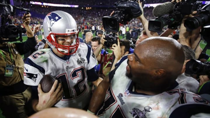 Feb 1, 2015; Glendale, AZ, USA; New England Patriots quarterback Tom Brady celebrates with defensive tackle Vince Wilfork (75) after defeating the Seattle Seahawks in Super Bowl XLIX at University of Phoenix Stadium. Mandatory Credit: Mark J. Rebilas-USA TODAY Sports