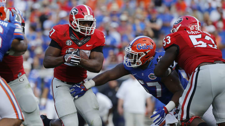 Oct 29, 2016; Jacksonville, FL, USA; Georgia Bulldogs running back Nick Chubb (27) runs with the ball as Florida Gators defensive lineman Caleb Brantley (57) defends during the first half at EverBank Field. Mandatory Credit: Kim Klement-USA TODAY Sports