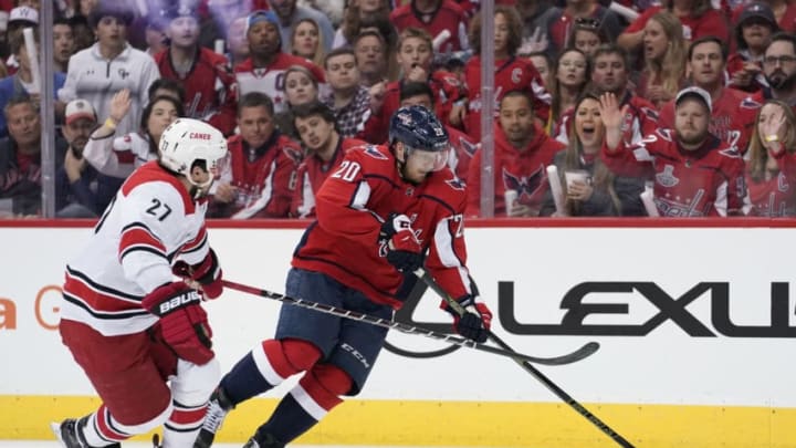 WASHINGTON, DC - APRIL 20: Justin Faulk #27 of the Carolina Hurricanes and Lars Eller #20 of the Washington Capitals battle for the puck in the first period in Game Five of the Eastern Conference First Round during the 2019 NHL Stanley Cup Playoffs at Capital One Arena on April 20, 2019 in Washington, DC. (Photo by Patrick McDermott/NHLI via Getty Images)