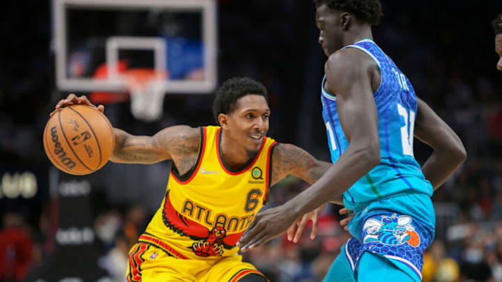 Dec 5, 2021; Atlanta, Georgia, USA; Atlanta Hawks guard Lou Williams (6) dribbles the ball as Charlotte Hornets forward JT Thor (21) defends in the second half at State Farm Arena. Mandatory Credit: Brett Davis-USA TODAY Sports