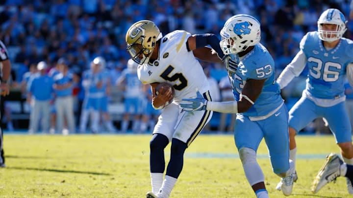 Nov 5, 2016; Chapel Hill, NC, USA; Georgia Tech Yellow Jackets quarterback Justin Thomas (5) tackled by North Carolina Tar Heels defensive linemen Malik Carney (53) during the third quarter at Kenan Memorial Stadium. The North Carolina Tar Heels defeated the Georgia Tech Yellow Jackets 48-20. Mandatory Credit: James Guillory-USA TODAY Sports