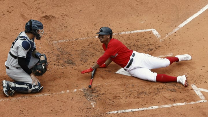 BOSTON, MA - JULY 25: Rafael Devers #11 of the Boston Red Sox looks back at Gary Sanchez #24 of the New York Yankees after he was almost hit by a pitch during the second inning at Fenway Park on July 25, 2021 in Boston, Massachusetts. (Photo By Winslow Townson/Getty Images)