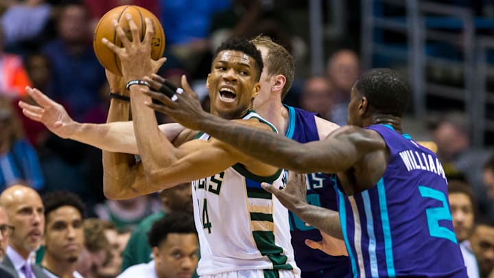 Apr 10, 2017; Milwaukee, WI, USA; Milwaukee Bucks forward Giannis Antetokounmpo (34) looks to pass the ball under pressure from Charlotte Hornets forward Marvin Williams (2) during the first quarter at BMO Harris Bradley Center. Mandatory Credit: Jeff Hanisch-USA TODAY Sports