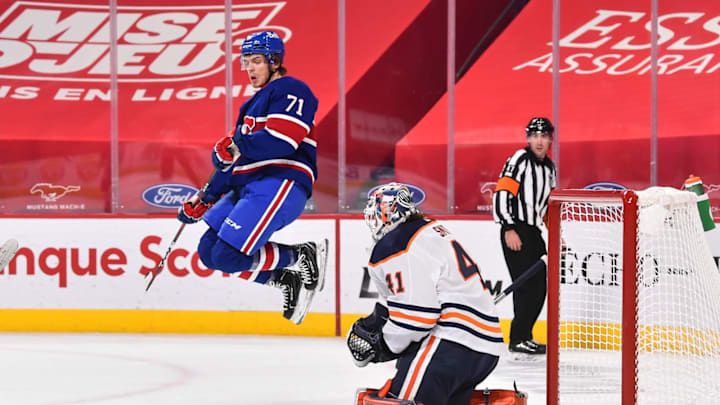 MONTREAL, QC – FEBRUARY 11: Jake Evans #71 of the Montreal Canadiens jumps in the air in front of goaltender Mike Smith #41 of the Edmonton Oilers during the second period at the Bell Centre on February 11, 2021 in Montreal, Canada. (Photo by Minas Panagiotakis/Getty Images)