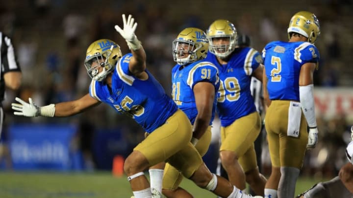 PASADENA, CA - SEPTEMBER 03: Jacob Tuioti-Mariner #91 and Jaelan Phillips #15 of the UCLA Bruins react to sacking Kellen Mond #11 of the Texas A&M Aggies during the second half of a game at the Rose Bowl on September 3, 2017 in Pasadena, California. (Photo by Sean M. Haffey/Getty Images)