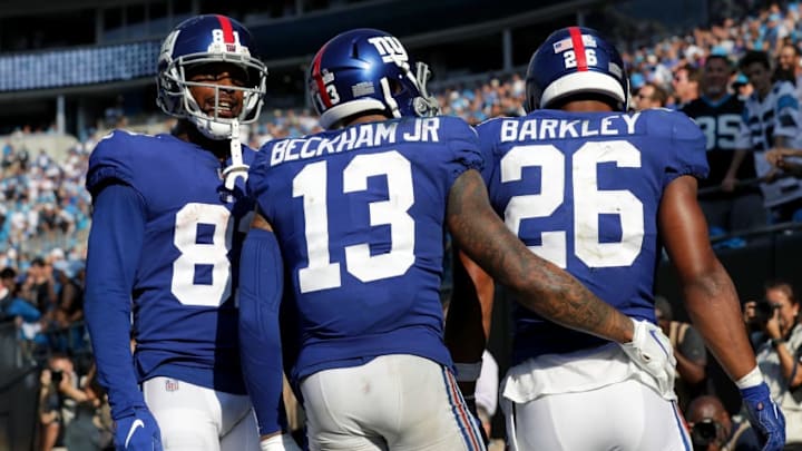 NFL DRAFT DFS: CHARLOTTE, NC - OCTOBER 07: Odell Beckham Jr #13 checks on teammate Saquon Barkley #26 of the New York Giants after a fourth quarter touchdown against the Carolina Panthers during their game at Bank of America Stadium on October 7, 2018 in Charlotte, North Carolina. (Photo by Streeter Lecka/Getty Images)