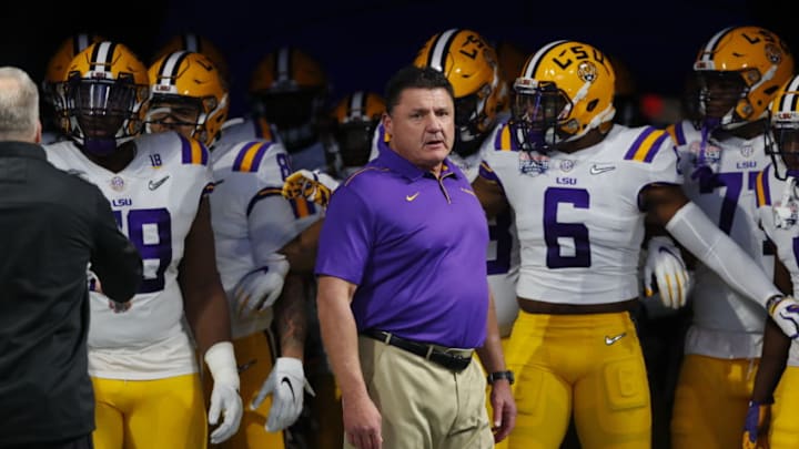 ATLANTA, GEORGIA - DECEMBER 28: Head coach Ed Orgeron of the LSU Tigers and team run onto the to take on the Oklahoma Sooners in the Chick-fil-A Peach Bowl at Mercedes-Benz Stadium on December 28, 2019 in Atlanta, Georgia. (Photo by Kevin C. Cox/Getty Images)