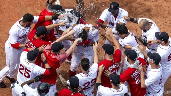 BOSTON, MA - JULY 14: Xander Bogaerts #2 of the Boston Red Sox is mobbed by teammates after hitting a walk-off grand slam home run during the tenth inning of a game against the Toronto Blue Jays on July 14, 2018 at Fenway Park in Boston, Massachusetts. (Photo by Billie Weiss/Boston Red Sox/Getty Images)