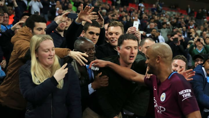 LONDON, ENGLAND - APRIL 14: Vincent Kompany of Manchester City celebrates victory with the Manchester City fans after the Premier League match between Tottenham Hotspur and Manchester City at Wembley Stadium on April 14, 2018 in London, England. (Photo by Victoria Haydn/Man City via Getty Images)
