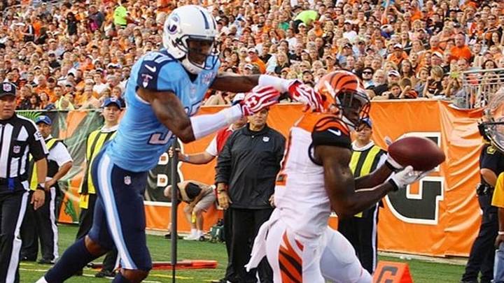 Aug 17, 2013; Cincinnati, OH, USA; Cincinnati Bengals wide receiver Mohamed Sanu (12) catches a pass in the end zone for a touchdown against Tennessee Titans cornerback Tommie Campbell (37) at Paul Brown Stadium. Mandatory Credit: Brian Spurlock-USA TODAY Sports