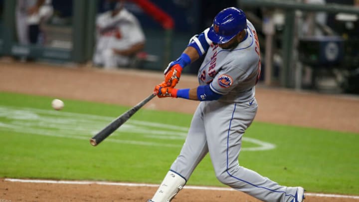 Aug 1, 2020; Atlanta, Georgia, USA; New York Mets second baseman Robinson Cano (24) hits an RBI single against the Atlanta Braves in the fifth inning at Truist Park. Mandatory Credit: Brett Davis-USA TODAY Sports