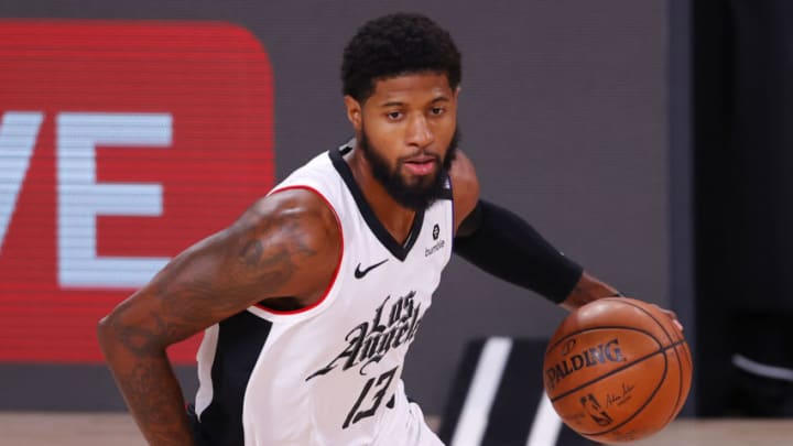 LAKE BUENA VISTA, FLORIDA - AUGUST 21: Paul George (13) of the LA Clippers drives against the Dallas Mavericks during the first quarter in Game Three of the Western Conference First Round during the 2020 NBA Playoffs at AdventHealth Arena at ESPN Wide World Of Sports Complex on August 21, 2020 in Lake Buena Vista, Florida. NOTE TO USER: User expressly acknowledges and agrees that, by downloading and or using this photograph, User is consenting to the terms and conditions of the Getty Images License Agreement. (Photo by Mike Ehrmann/Getty Images)