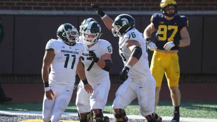 Michigan State Spartans running back Connor Heyward (11) celebrates with teammates after scoring a touchdown in the fourth quarter against the Michigan Wolverines at Michigan Stadium in Ann Arbor, Saturday, Oct. 31, 2020.Sad Michigan football