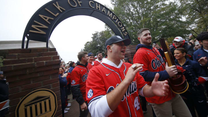 Nov 12, 2022; Oxford, Mississippi, USA; Mississippi Rebels Dylan DeLucia and Tim Elko lead the National Champion baseball team walks through the Walk of Champions in the Grove at the University of Mississippi before the game between the Alabama Crimson Tide and the Mississippi Rebels. Mandatory Credit: Petre Thomas-USA TODAY Sports