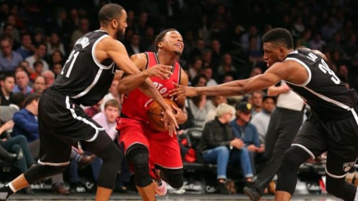 Jan 6, 2016; Brooklyn, NY, USA; Toronto Raptors point guard Kyle Lowry (7) is fouled by Brooklyn Nets shooting guard Wayne Ellington (21) in front of Brooklyn Nets power forward Thaddeus Young (30) during the second quarter at Barclays Center. Mandatory Credit: Brad Penner-USA TODAY Sports