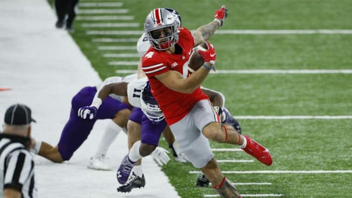 Ohio State Buckeyes wide receiver Julian Fleming (4) tiptoes up the sideline after making a catch during the second quarter of the Big Ten Championship football game against the Northwestern Wildcats at Lucas Oil Stadium in Indianapolis on Saturday, Dec. 19, 2020.Big Ten Championship Ohio State Northwestern