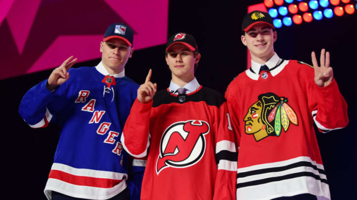 Jun 21, 2019; Vancouver, BC, Canada; From left Kaapo Kakko (New York Rangers) , Jack Hughes (New Jersey Devils) and Kirby Dach (Chicago Blackhawks) pose with their new team jerseys after being drafted as the top three overall picks in the first round of the 2019 NHL Draft at Rogers Arena. Mandatory Credit: Anne-Marie Sorvin-USA TODAY Sports