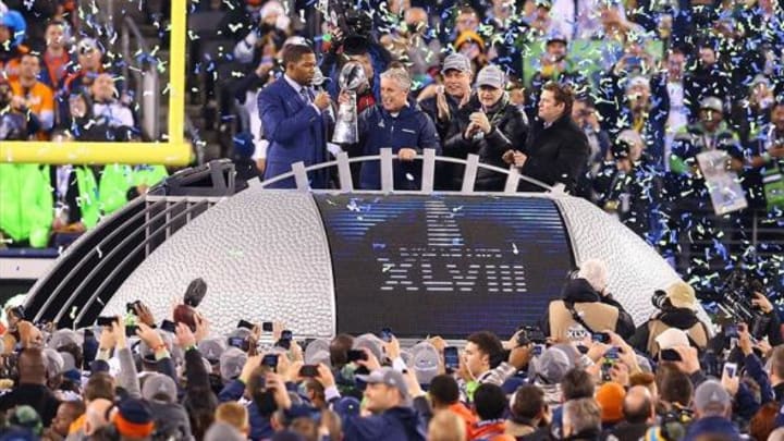 Feb 2, 2014; East Rutherford, NJ, USA; Seattle Seahawks head coach Pete Carroll celebrates with the Vince Lombardi Trophy after winning Super Bowl XLVIII against the Denver Broncos at MetLife Stadium. Mandatory Credit: Ed Mulholland-USA TODAY Sports