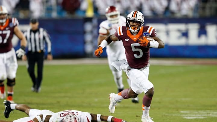 Dec 29, 2016; Charlotte, NC, USA; Virginia Tech Hokies wide receiver Cam Phillips (5) outruns Arkansas Razorbacks defensive back Santos Ramirez (9) in the third quarter during the Belk Bowl at Bank of America Stadium. Mandatory Credit: Jeremy Brevard-USA TODAY Sports