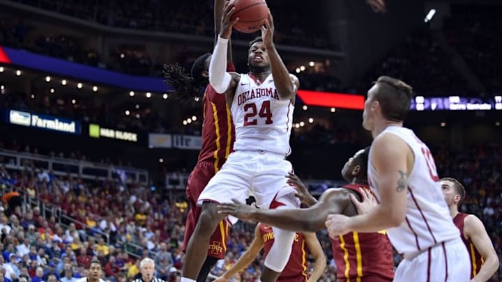 Mar 10, 2016; Kansas City, MO, USA; Oklahoma Sooners guard Buddy Hield (24) shoots as Iowa State Cyclones forward Jameel McKay (1) defends in the first half during the Big 12 Conference tournament at Sprint Center. Mandatory Credit: Denny Medley-USA TODAY Sports