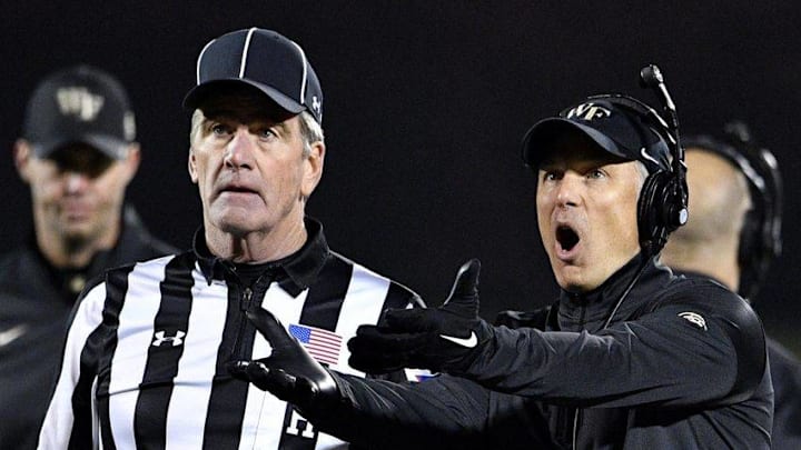 Nov 12, 2016; Louisville, KY, USA; Wake Forest Demon Deacons head coach Dave Clawson discusses a targeting call with Head Linesman Joseph Griever during the second half against the Louisville Cardinals at Papa John