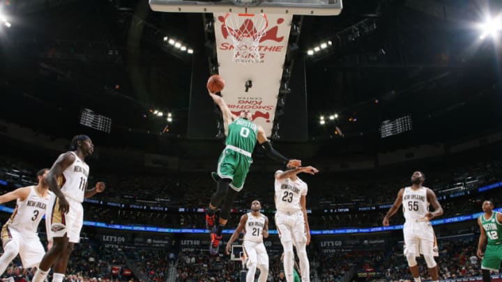 Boston Celtics forward Jayson Tatums dunks with Anthony Davis looking on. (Photo by Layne Murdoch Jr./NBAE via Getty Images)