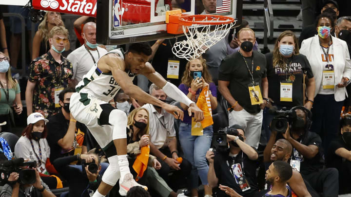 Giannis finishes the alley-oop as Adele watches