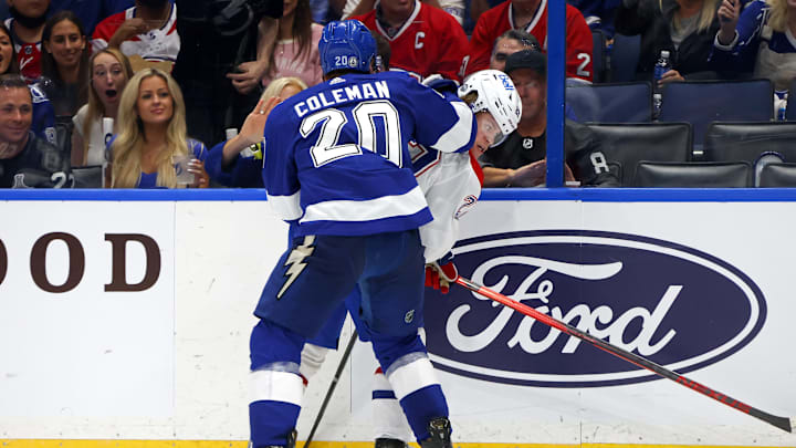 TAMPA, FLORIDA – JUNE 28: Cole Caufield #22 of the Montreal Canadiens is checked into the boards by Blake Coleman #20 of the Tampa Bay Lightning   (Photo by Bruce Bennett/Getty Images)