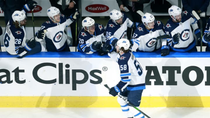 EDMONTON, ALBERTA - AUGUST 03: Jansen Harkins #58 of the Winnipeg Jets celebrates his goal with teammates on the bench in the first period against the Calgary Flames during Game Two of the Western Conference Qualification Round prior to the 2020 NHL Stanley Cup Playoffs at Rogers Place on August 03, 2020 in Edmonton, Alberta. (Photo by Jeff Vinnick/Getty Images)