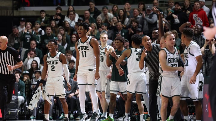EAST LANSING, MI – DECEMBER 30: A.J. Hoggard #11 of the Michigan State Spartans and the Michigan State Spartans bench celebrate during the second half against the Buffalo Bulls at Breslin Center on December 30, 2022 in East Lansing, Michigan. (Photo by Rey Del Rio/Getty Images)