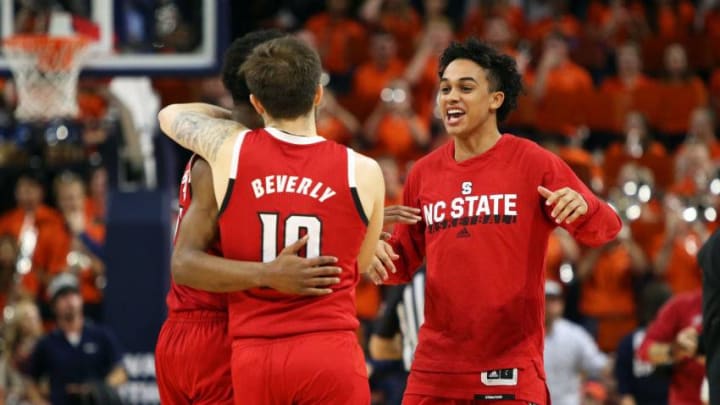 CHARLOTTESVILLE, VA - JANUARY 20: Chase Graham #2 celebrates with Markell Johnson #11 and Braxton Beverly #10 of the North Carolina State Wolfpack after the end of a game against the Virginia Cavaliers at John Paul Jones Arena on January 20, 2020 in Charlottesville, Virginia. (Photo by Ryan M. Kelly/Getty Images)